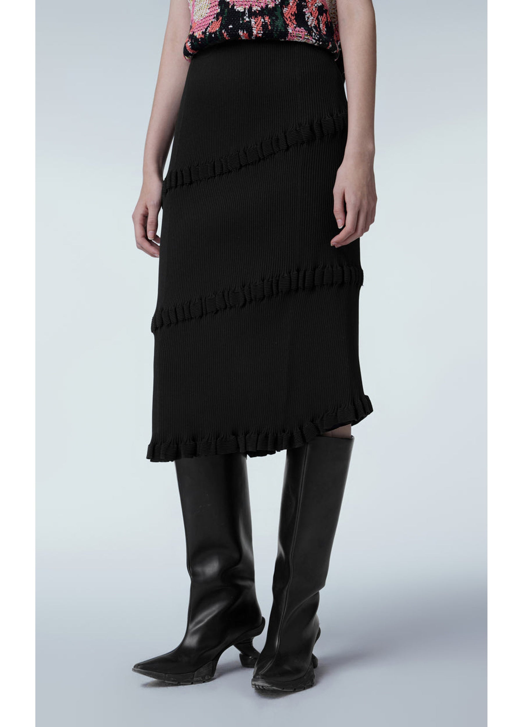 Asymmetric hem of JNBY Skirt paired with bold ankle boots Black