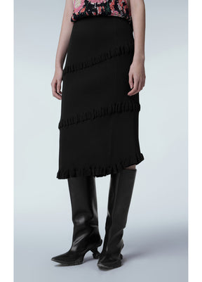 Asymmetric hem of JNBY Skirt paired with bold ankle boots Black