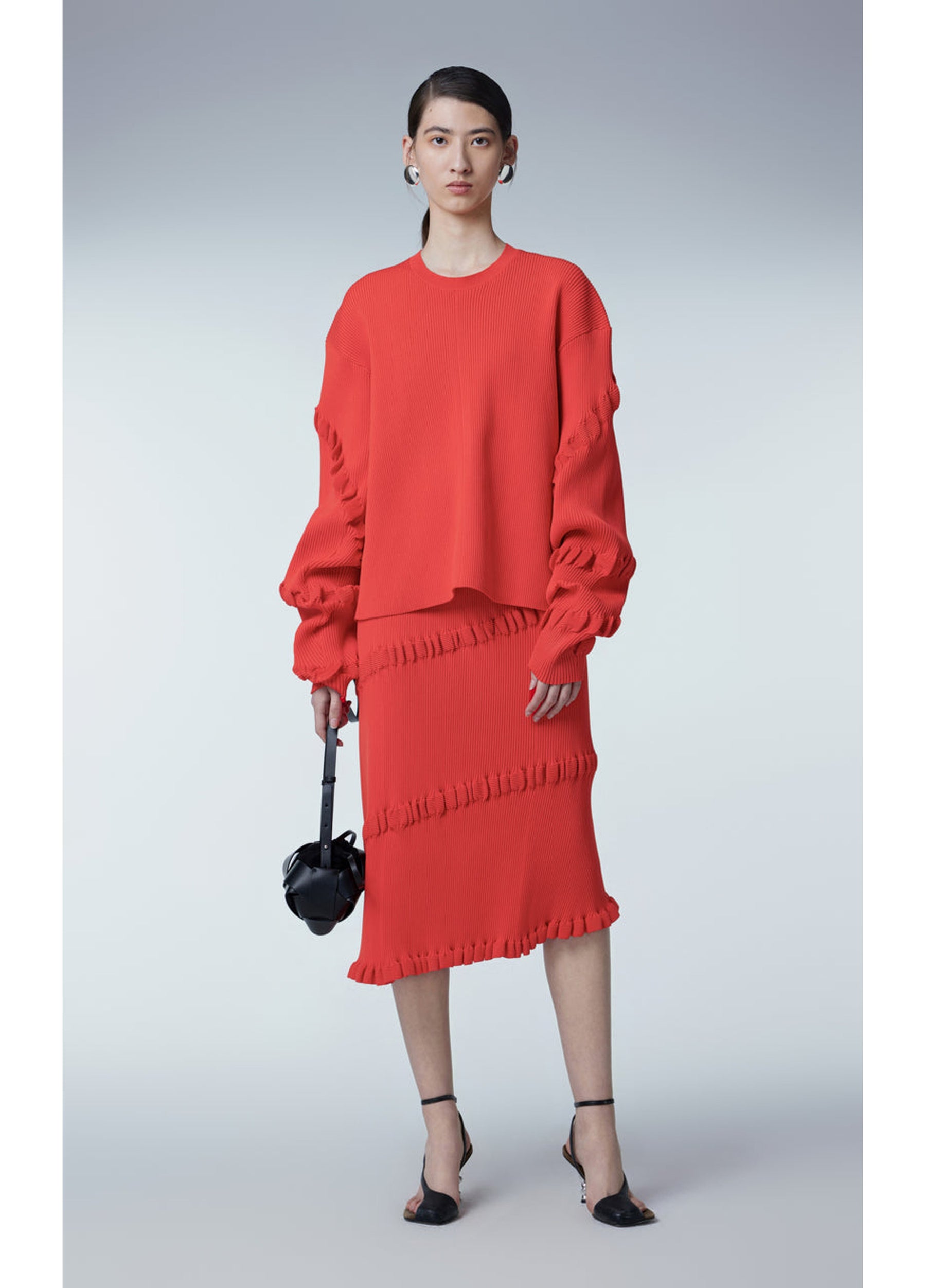 JNBY Asymmetric Calf-Length Skirt styled with a tucked-out blouse.