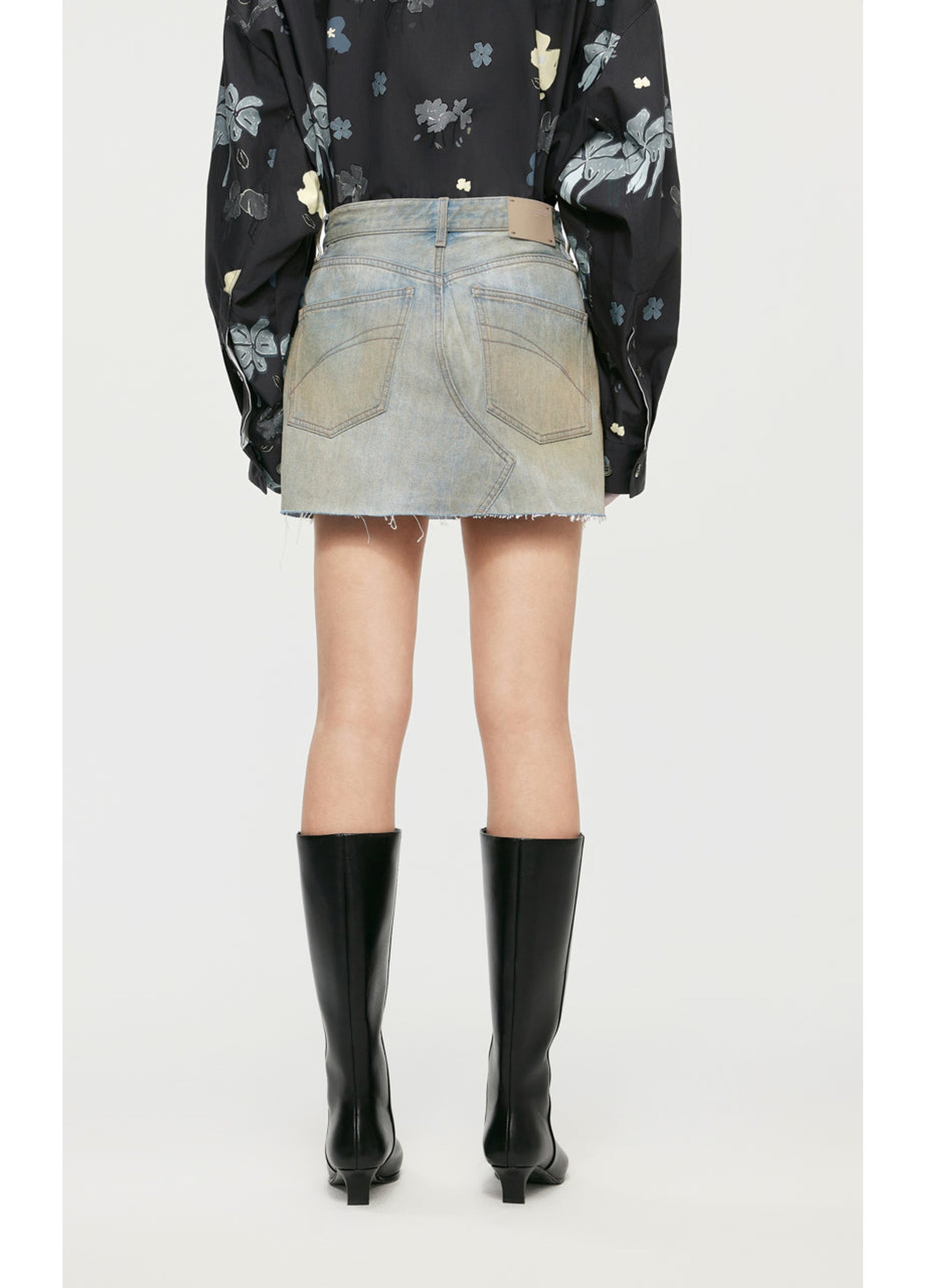 Back JNBY Skirt paired with a cropped jacket and ankle boots.